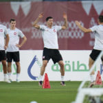 
              Poland's Robert Lewandowski, center, works out with teammates during a training session in Doha, Qatar, Saturday, Dec. 3, 2022. Poland will play against France in the round of 16 phase of the World Cup soccer tournament on Dec. 4. (AP Photo/Julio Cortez)
            