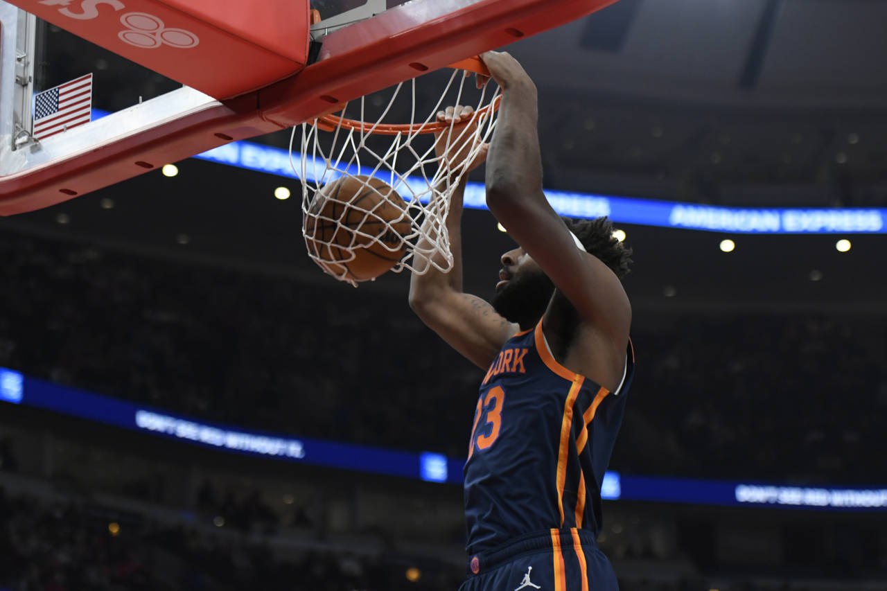 New York Knicks' Mitchell Robinson (23) dunks during the first half of an NBA basketball game again...