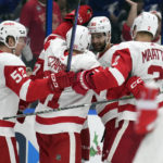 
              Detroit Red Wings' Jonatan Berggren (52) celebrates with teammates, including defenseman Olli Maatta (2) after scoring against the Tampa Bay Lightning during the third period of an NHL hockey game Tuesday, Dec. 6, 2022, in Tampa, Fla. (AP Photo/Chris O'Meara)
            
