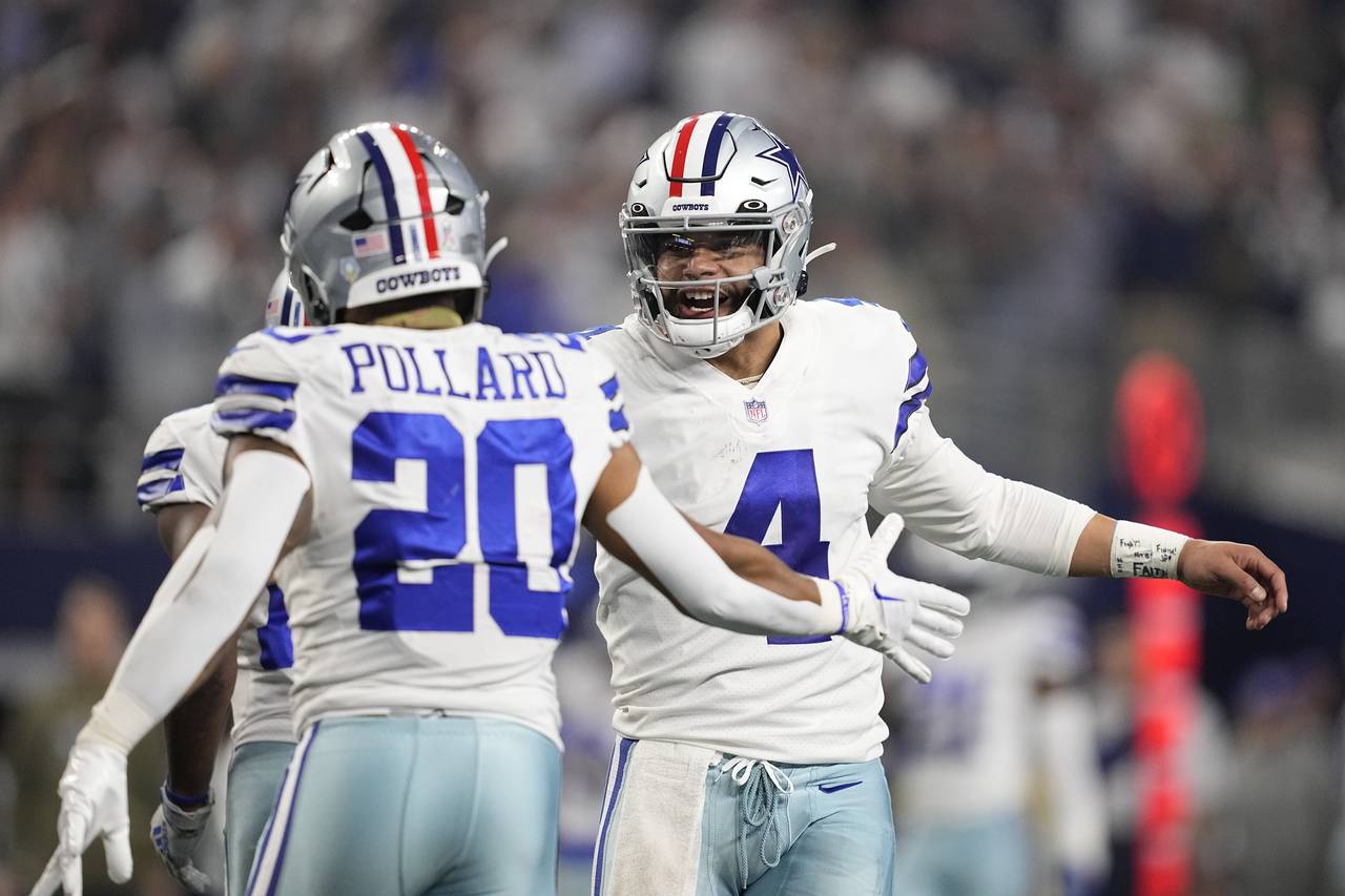 Dallas Cowboys quarterback Dak Prescott (4) celebrates a touchdown by Tony Pollard (20) during the ...