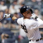 
              FILE - New York Yankees' Aaron Judge hits an RBI single during the first inning of the team's baseball game against the Tampa Bay Rays on Saturday, Sept. 10, 2022, in New York.  After hitting 62 home runs to break an American League record that lasted six decades, Judge has been voted The Associated Press Male Athlete of the Year by a panel of 40 sports writers and editors from news outlets across the country.   (AP Photo/Adam Hunger)
            
