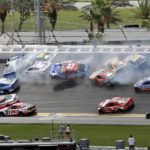 
              FILE - Chris Buescher (17), Daniel Suarez (99), Denny Hamlin (11), Justin Haley (31), Ricky Stenhouse Jr. (47), Aric Almirola (10) and others get involved in a multi-car accident between Turns 1 and 2 during a NASCAR Cup Series auto race at Daytona International Speedway on Aug. 28, 2022, in Daytona Beach, Fla. The most meticulously designed and intently controlled racecar in NASCAR history leveled the field in 2022. The so-called Next Gen car resulted in 19 different winners over 36 races and laded two guys their first shot at a championship in the season finale. (AP Photo/David Graham, File)
            
