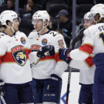 
              Florida Panthers center Carter Verhaeghe, center, is congratulated by defenseman Brandon Montour, left, center Sam Bennett and defenseman Marc Staal (18) after scoring against the Seattle Kraken during the first period of an NHL hockey game Saturday, Dec. 3, 2022, in Seattle. (AP Photo/John Froschauer)
            