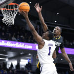 
              Northwestern guard Chase Audige (1) drives to the basket as Prairie View A&M guard Hegel Augustin guards during the second half of an NCAA college basketball game in Evanston, Ill., Sunday, Dec. 11, 2022. Northwestern won 61-51. (AP Photo/Nam Y. Huh)
            
