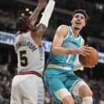 
              Charlotte Hornets guard LaMelo Ball, right, drives the lane to the rim as Denver Nuggets guard Kentavious Caldwell-Pope defends in the second half of an NBA basketball game Sunday, Dec. 18, 2022, in Denver. (AP Photo/David Zalubowski)
            