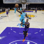
              Charlotte Hornets guard Terry Rozier (3) scores past Los Angeles Lakers guard Lonnie Walker IV during the first half of an NBA basketball game Friday, Dec. 23, 2022, in Los Angeles. (AP Photo/Marcio Jose Sanchez)
            