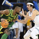 
              UCLA guard Jaime Jaquez Jr., right, guards against Oregon forward Quincy Guerrier during the second half of an NCAA college basketball game, Sunday, Dec. 4, 2022, in Los Angeles. (AP Photo/John McCoy)
            