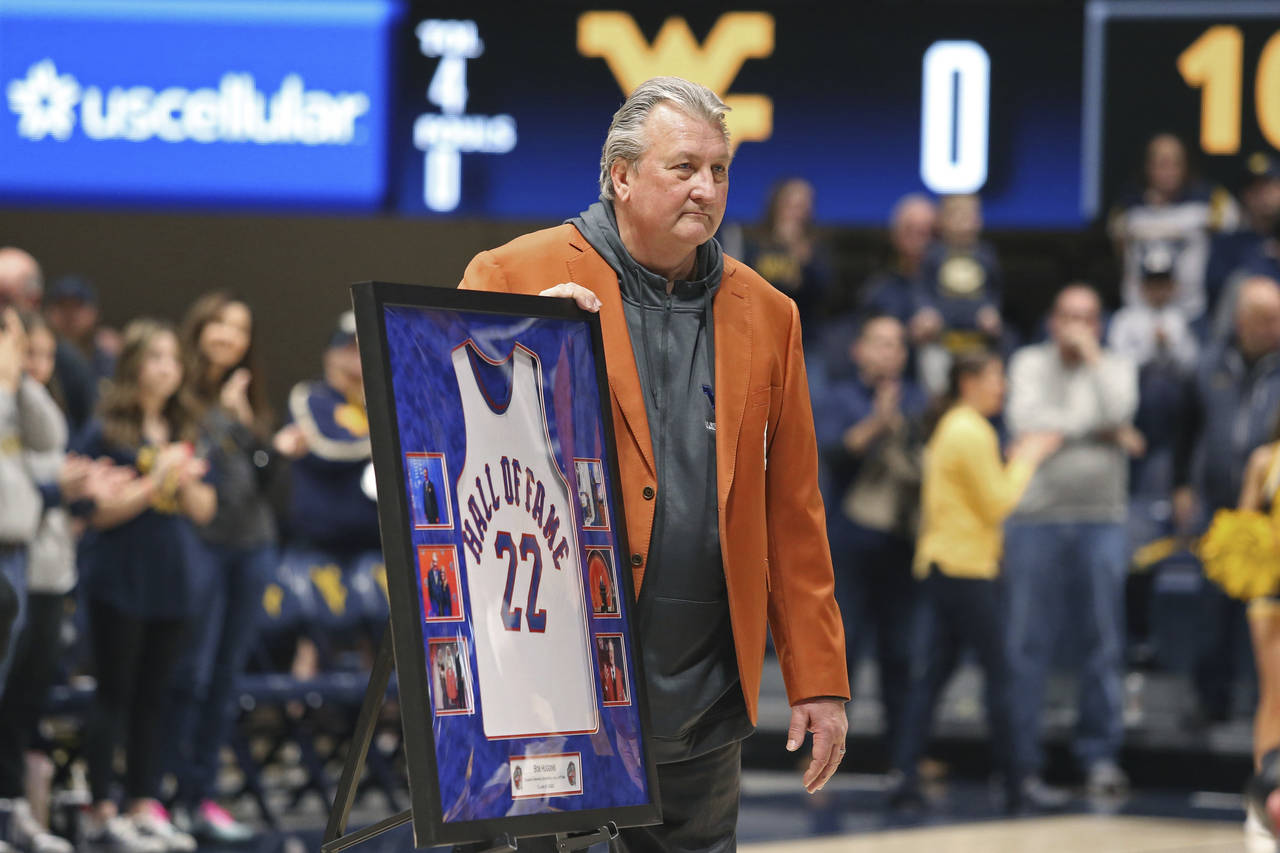 West Virginia coach Bob Huggins is honored during the first half of an NCAA college basketball game...