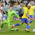 
              FILE - Brazil's Neymar takes the ball past Croatia's goalkeeper Dominik Livakovic on his way to scoring his side's first goal during the World Cup quarterfinal soccer match between Croatia and Brazil, at the Education City Stadium in Al Rayyan, Qatar, Friday, Dec. 9, 2022. (AP Photo/Andre Penner, File)
            