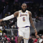 
              Los Angeles Lakers forward LeBron James (6) reacts after scoring against the Washington Wizards during the first half of an NBA basketball game, Sunday, Dec. 4, 2022, in Washington. (AP Photo/Jess Rapfogel)
            