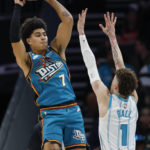 
              Detroit Pistons guard Killian Hayes, left, passes over Charlotte Hornets guard LaMelo Ball (1) during the first half of an NBA basketball game in Charlotte, N.C., Wednesday, Dec. 14, 2022. (AP Photo/Nell Redmond)
            