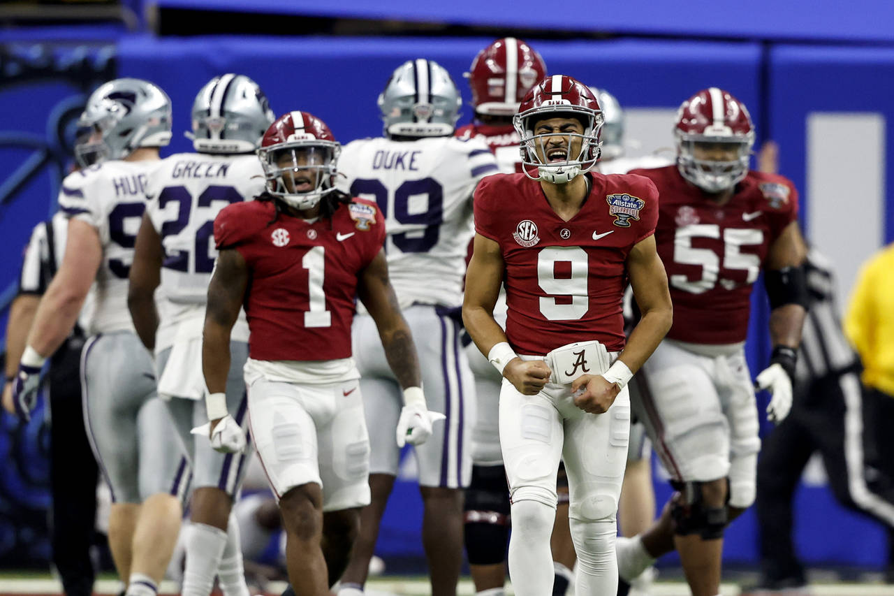 Alabama quarterback Bryce Young (9) reacts after throwing a touchdown pass during the first half of...