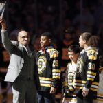 
              FILE - Hockey Hall of Famer Willie O'Ree, left, waves to the crowd before dropping the ceremonial puck before an NHL hockey game between the Boston Bruins and the Edmonton Oilers in Boston, Jan. 4, 2020. The first elite Indigenous hockey players played well before Willie O’Ree became the first Black player to skate in an NHL game in January 1958. (AP Photo/Michael Dwyer, File)
            