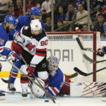 
              New York Rangers goaltender Igor Shesterkin (31) holds onto New Jersey Devils left wing Tomas Tatar's (90) leg as he tends net during the second period of an NHL hockey game, Monday, Dec. 12, 2022, at Madison Square Garden in New York. (AP Photo/Mary Altaffer)
            