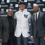 
              New York Yankees' captain Aaron Judge, center, poses for a picture with former Yankees captains Derek Jeter, right, and Willie Randolph during a news conference at Yankee Stadium, Wednesday, Dec. 21, 2022, in New York. Judge has been appointed captain of the New York Yankees after agreeing to a $360 million, nine-year contract to remain in pinstripes. (AP Photo/Seth Wenig)
            