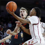 
              Southern California guard Boogie Ellis, right, drives to the basket against Oregon State forward Tyler Bilodeau during the second half of an NCAA college basketball game in Los Angeles, Sunday, Dec. 4, 2022. (AP Photo/Alex Gallardo)
            