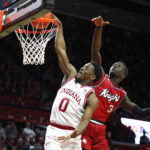 
              Indiana guard Xavier Johnson (0) drives to the basket against Rutgers forward Mawot Mag (3) during the first half of an NCAA college basketball game in Piscataway, N.J., Saturday, Dec. 3, 2022. (AP Photo/Noah K. Murray)
            
