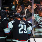 
              Seattle Kraken players including defenseman Adam Larsson (6) and Vince Dunn (29), celebrate after Seattle Kraken center Ryan Donato, center, scored against the Calgary Flames during the first period of an NHL hockey game, Wednesday, Dec. 28, 2022, in Seattle. (AP Photo/Lindsey Wasson)
            