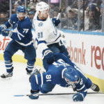 
              Tampa Bay Lightning's Steven Stamkos (91) goes to the boards with Toronto Maple Leafs' John Tavares during the third period of an NHL hockey game, Tuesday, Dec. 20, 2022 in Toronto. (Chris Young/The Canadian Press via AP)
            
