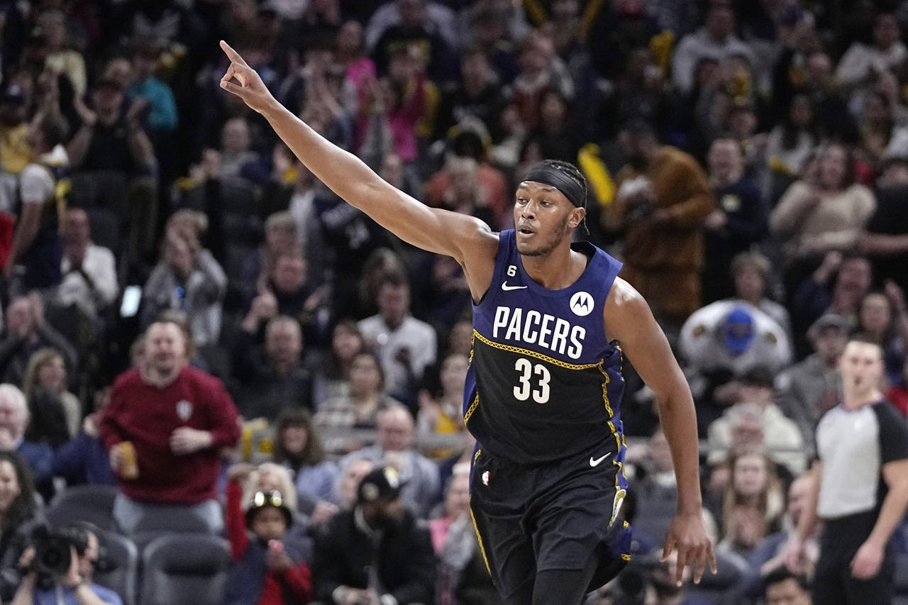 Indiana Pacers' Myles Turner reacts after making a shot during the second half of an NBA basketball...