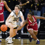 
              North Carolina State guard Diamond Johnson (3) steals the ball from Iowa guard Kate Martin (20) during the first half of an NCAA college basketball game, Thursday, Dec. 1, 2022, in Iowa City, Iowa. (AP Photo/Charlie Neibergall)
            