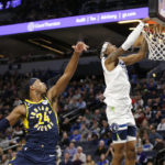 
              Minnesota Timberwolves forward Jaden McDaniels (3) dunks in front of Indiana Pacers guard Buddy Hield (24) in the second quarter of an NBA basketball game Wednesday, Dec. 7, 2022, in Minneapolis. (AP Photo/Andy Clayton-King)
            