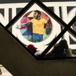 
              A man rests in front of a mural with an image of soccer legend Pele, created by Brazilian street artist Eduardo Kobra in Santos, Brazil, Monday, Dec. 26, 2022. (AP Photo/Matias Delacroix)
            