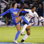 
              UCLA's Ally Lemos, left, and Alabama's Gianna Paul compete for the ball during the first half of an NCAA women's soccer tournament semifinal in Cary, N.C., Friday, Dec. 2, 2022. (AP Photo/Ben McKeown)
            