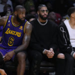 
              Los Angeles Lakers forward LeBron James, left, sits next to injured teammates Anthony Davis, center, and Juan Toscano-Anderson during the first half of the team's NBA basketball game against the Charlotte Hornets on Friday, Dec. 23, 2022, in Los Angeles. (AP Photo/Marcio Jose Sanchez)
            