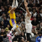 
              Los Angeles Lakers guard Russell Westbrook, left, shoots as Miami Heat forward Duncan Robinson defends during the first half of an NBA basketball game, Wednesday, Dec. 28, 2022, in Miami. (AP Photo/Lynne Sladky)
            