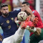 
              France's Olivier Giroud and Morocco's Noussair Mazraoui, right, vie for the ball during the World Cup semifinal soccer match between France and Morocco at the Al Bayt Stadium in Al Khor, Qatar, Wednesday, Dec. 14, 2022. (AP Photo/Manu Fernandez)
            