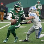 
              New York Jets quarterback Zach Wilson (2) scrambles under pressure from Detroit Lions linebacker Alex Anzalone (34) during the fourth quarter of an NFL football game, Sunday, Dec. 18, 2022, in East Rutherford, N.J. (AP Photo/Seth Wenig)
            