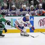 
              Edmonton Oilers center Connor McDavid (97) controls the puck as Dallas Stars center Roope Hintz follows behind in the second period of an NHL hockey game, Wednesday, Dec. 21, 2022, in Dallas. (AP Photo/Tony Gutierrez)
            