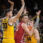 
              Wisconsin forward Tyler Wahl (5) looks to pass between Iowa guard Connor McCaffery (30) and guard Carter Kingsbury (14) during the first half of an NCAA college basketball game, Sunday, Dec. 11, 2022, in Iowa City, Iowa. (AP Photo/Charlie Neibergall)
            