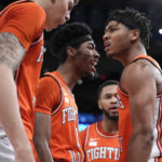 
              Illinois' Terrence Shannon Jr., right, reacts after scoring and drawing a foul in overtime during the team's NCAA college basketball game against Texas in the Jimmy V Classic, Tuesday, Dec. 6, 2022, in New York. (AP Photo/John Minchillo)
            