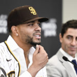 
              San Diego Padres' Xander Bogaerts, left, plays with his beard as general manager A.J. Preller looks on at a news conference held to announce that Bogaerts' $280 million, 11-year contact with the Padres has been finalized, Friday, Dec. 9, 2022, in San Diego. (AP Photo/Denis Poroy)
            