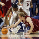 
              Auburn guard Chance Westry, left, and Colgate forward Sam Thomson, right, scramble for the ball during the first half of an NCAA college basketball game Friday, Dec. 2, 2022, in Auburn, Ala. (AP Photo/Butch Dill)
            