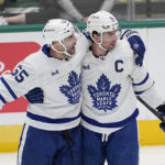 
              Toronto Maple Leafs' Mark Giordano (55) and John Tavares celebrate after Tavares scored against the Dallas Stars in the first period of an NHL hockey game Tuesday, Dec. 6, 2022, in Dallas. (AP Photo/Tony Gutierrez)
            