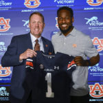 
              Newly named Auburn football coach Hugh Freeze, left, and Carnell Williams, who will stay on as running backs coach and associate head coach, pose for photos at a news conference Tuesday, Nov. 29, 2022, in Auburn, Ala. (AP Photo/Todd Van Emst)
            