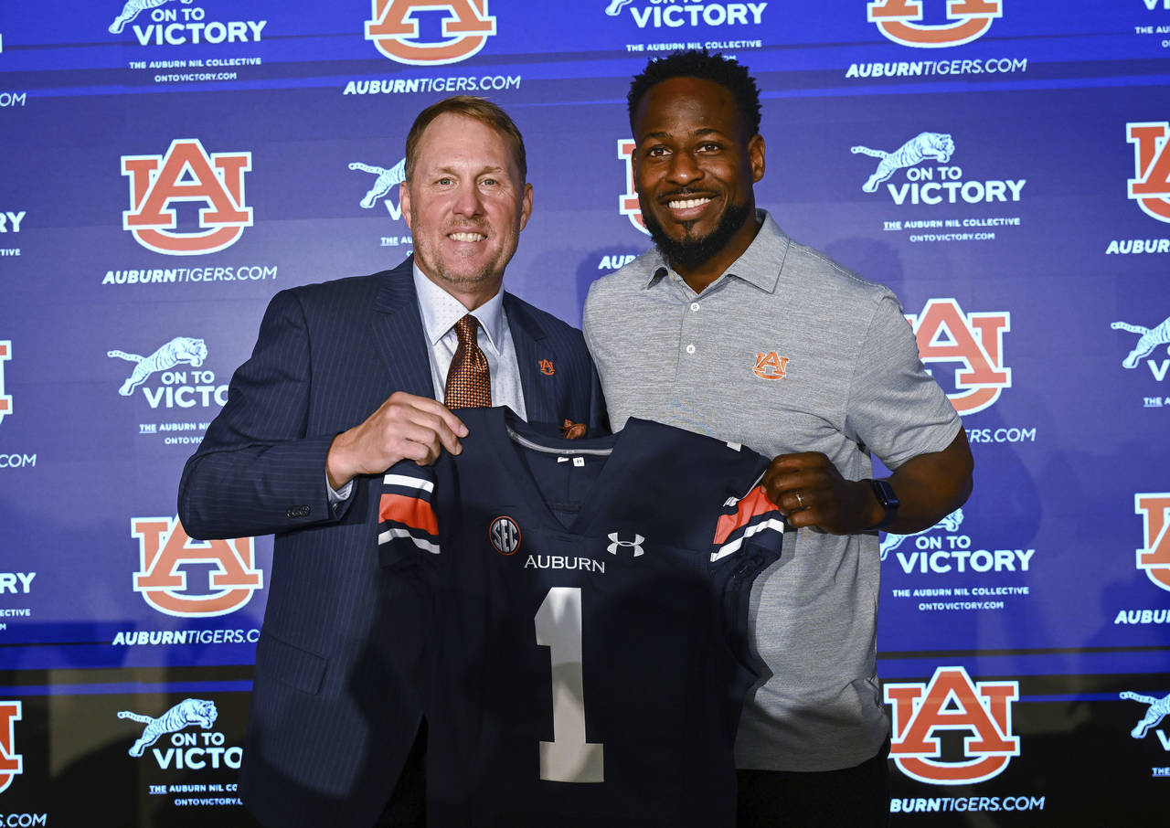 Newly named Auburn football coach Hugh Freeze, left, and Carnell Williams, who will stay on as runn...