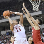 
              Arkansas guard Jordan Walsh (13) shoots over Bradley forward Malevy Leons during the first half of an NCAA college basketball game, Saturday, Dec. 17, 2022, in North Little Rock, Ark. (AP Photo/Michael Woods)
            