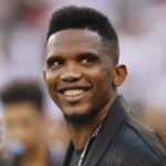 
              FILE - Soccer player Samuel Eto'o watches warmups before an International Champions Cup soccer match between Atletico Madrid and Real Madrid, Friday, July 26, 2019, in East Rutherford, N.J. Cameroon soccer federation president Samuel Eto'o was filmed apparently kicking a man to the ground in an altercation outside a World Cup stadium early on Tuesday. Eto'o had paused to pose for photos with fans near Stadium 974 after Brazil beat South Korea 4-1. Footage circulating on social media showed him then reacting to comments by a man holding a camera. (AP Photo/Steve Luciano, File)
            