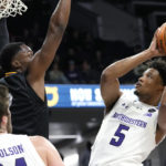
              Northwestern guard Julian Roper II, right, shoots against Prairie View A&M forward Braden Bell during the second half of an NCAA college basketball game in Evanston, Ill., Sunday, Dec. 11, 2022. (AP Photo/Nam Y. Huh)
            