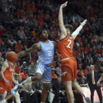 
              North Carolina's Caleb Love (2) passes while guarded by Virginia Tech's Grant Basile (21) in the first half of an NCAA college basketball game in Blacksburg Va., Sunday Dec. 4, 2022. (Matt Gentry/The Roanoke Times via AP)
            