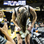 
              Iowa guard Caitlin Clark (22) signs a pair of her shoes after an NCAA college basketball game against Dartmouth, Wednesday, Dec. 21, 2022, at Carver-Hawkeye Arena in Iowa City, Iowa. Caitlin Clark had 20 points, 10 rebounds and six assists, and reached 2,000 career points as No. 13 Iowa beat Dartmouth 92-54 or its fifth straight victory.(Joseph Cress/Iowa City Press-Citizen via AP)
            