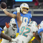 
              Los Angeles Chargers quarterback Justin Herbert, top, throws under pressure from Miami Dolphins defensive tackle Zach Sieler (92) during the second half of an NFL football game Sunday, Dec. 11, 2022, in Inglewood, Calif. (AP Photo/Mark J. Terrill)
            