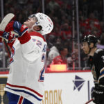 
              Montreal Canadiens right wing Cole Caufield (22) celebrates his goal as Washington Capitals defenseman Nick Jensen (3) looks on during the second period of an NHL hockey game Saturday, Dec. 31, 2022, in Washington. (AP Photo/Nick Wass)
            
