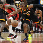 
              Houston Rockets guard Kevin Porter Jr., left, and Phoenix Suns guard Chris Paul chase the ball during the first half of an NBA basketball game, Tuesday, Dec. 13, 2022, in Houston. (AP Photo/Eric Christian Smith)
            
