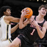 
              Davidson guard Reed Bailey (1) grabs a rebound over Purdue forward Trey Kaufman-Renn (4) in the first half of an NCAA college basketball game in Indianapolis, Saturday, Dec. 17, 2022. (AP Photo/Michael Conroy)
            