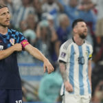 
              Croatia's Luka Modric adjusts his armband in front of Argentina's Lionel Messi during the World Cup semifinal soccer match between Argentina and Croatia at the Lusail Stadium in Lusail, Qatar, Tuesday, Dec. 13, 2022. (AP Photo/Martin Meissner)
            